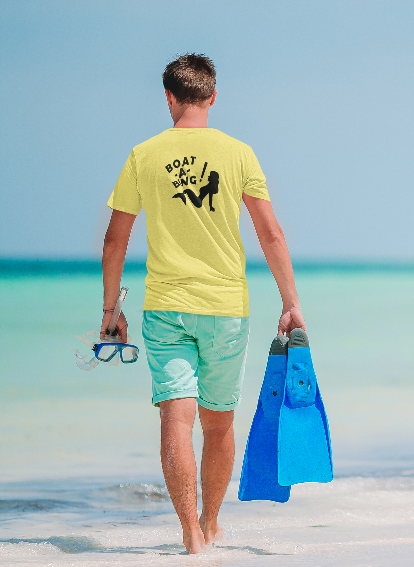 Man walking on the beach wearing the Boat-A-Bing Sirena moisture-wicking performance boating tee, back print