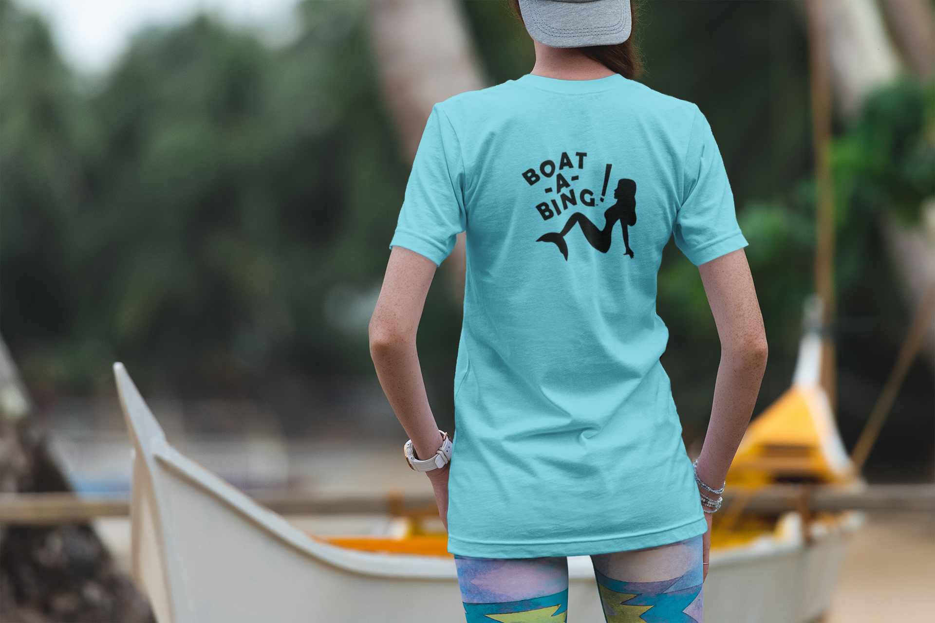Woman by a boat wearing the Boat-A-Bing! Sirena moisture-wicking performance boating tee