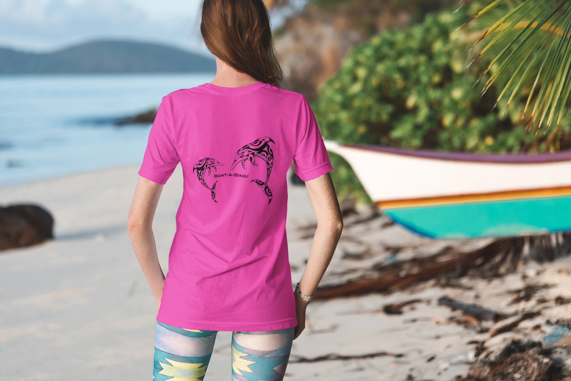 Dock pair by the water wearing Boat-A-Bing dolphins back-print performance boating shirts