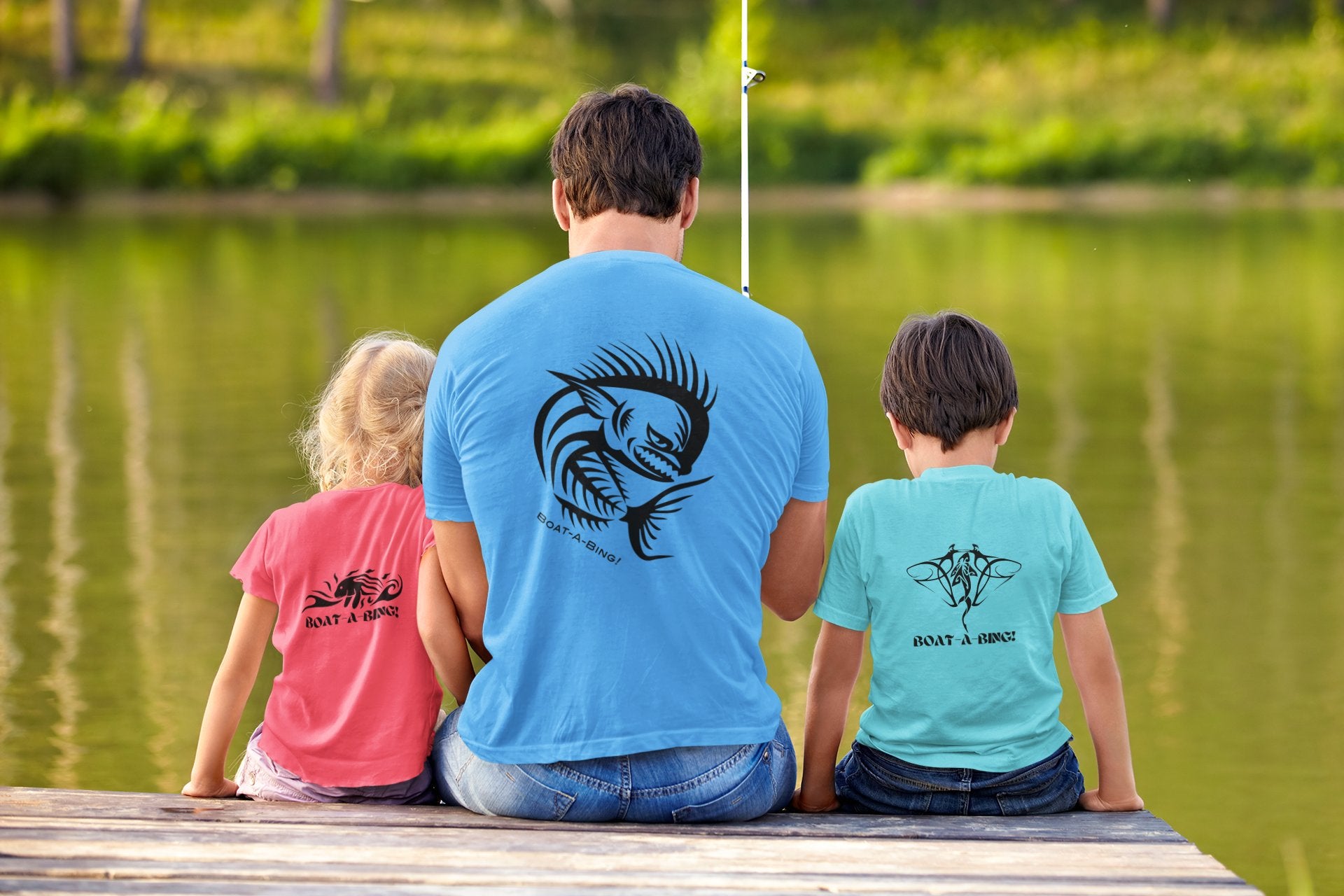 Dad and two kids lake fishing in Boat-A-Bing Angry Mahi back-print performance fishing shirts